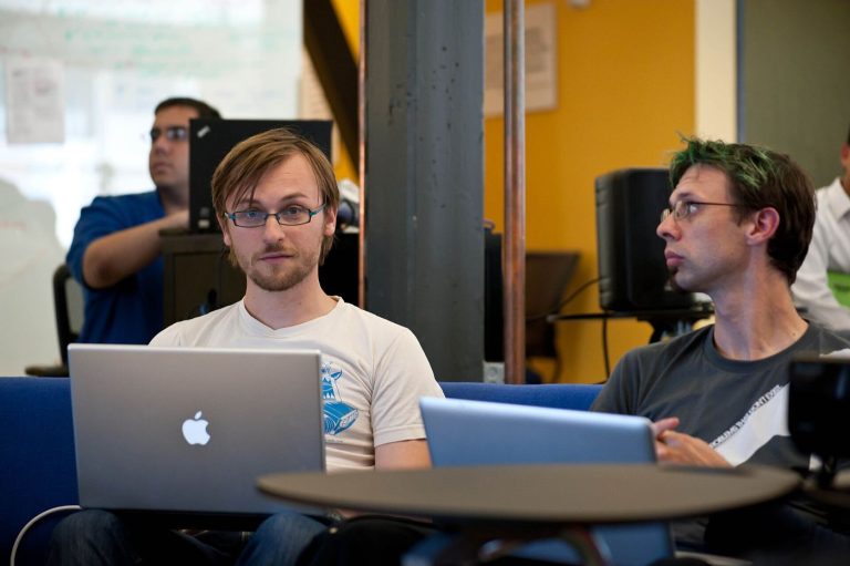 programmer reviewing code on a monitor