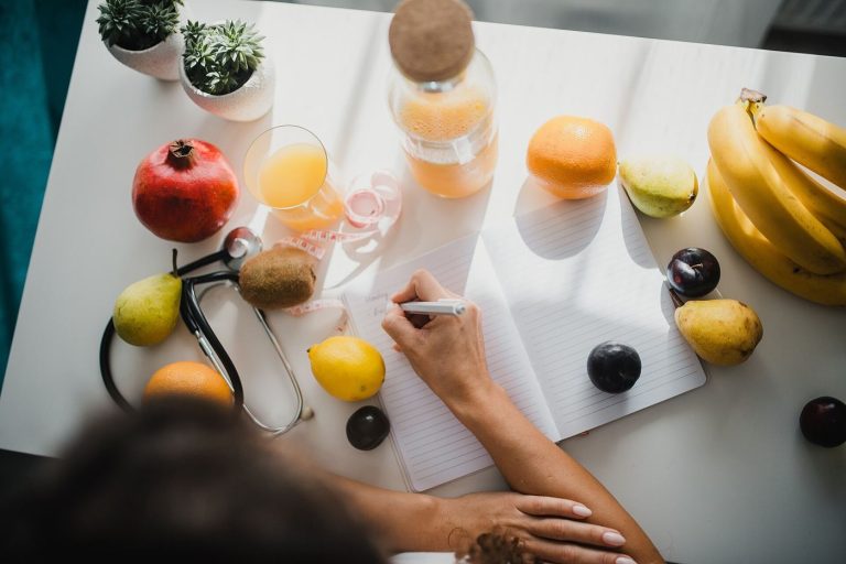Kitchen Table Journaling Helps Clear Everyday Mental Clutter An open notebook and pen rest on a kitchen table ready for reflective writing.